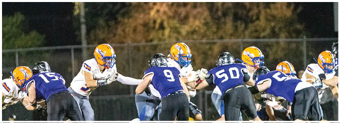 A group of football players on a field. Description generated by AI