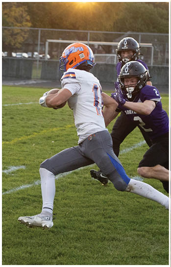 A football player running on the field. Description generated by AI