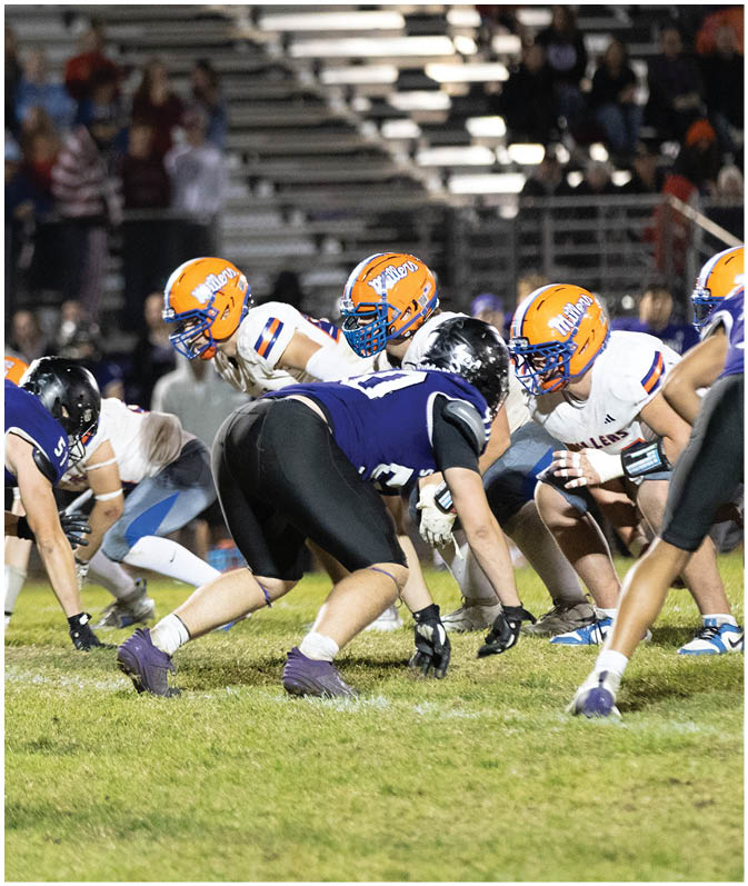 A group of football players wearing black and white uniforms. Description generated by AI