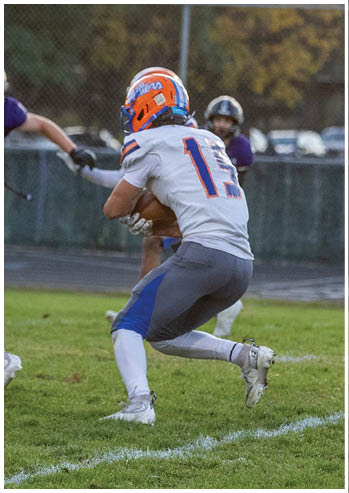 A football player running on the field. Description generated by AI