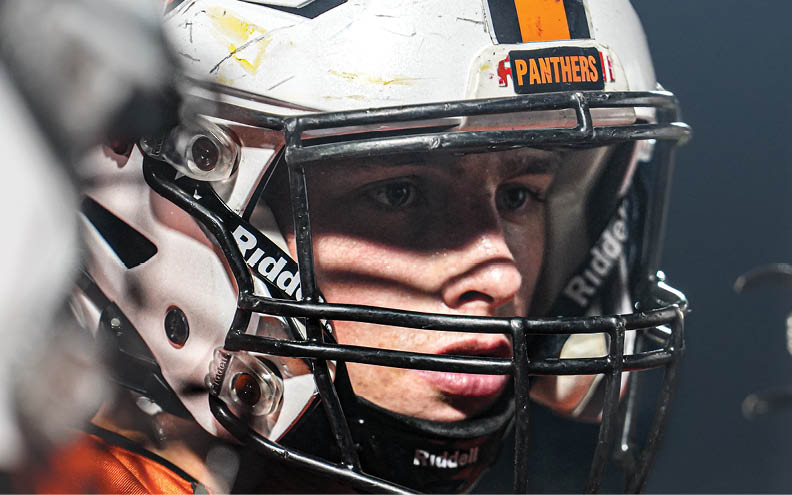 A football player wearing a helmet with the word Panthers on it. AI generated content