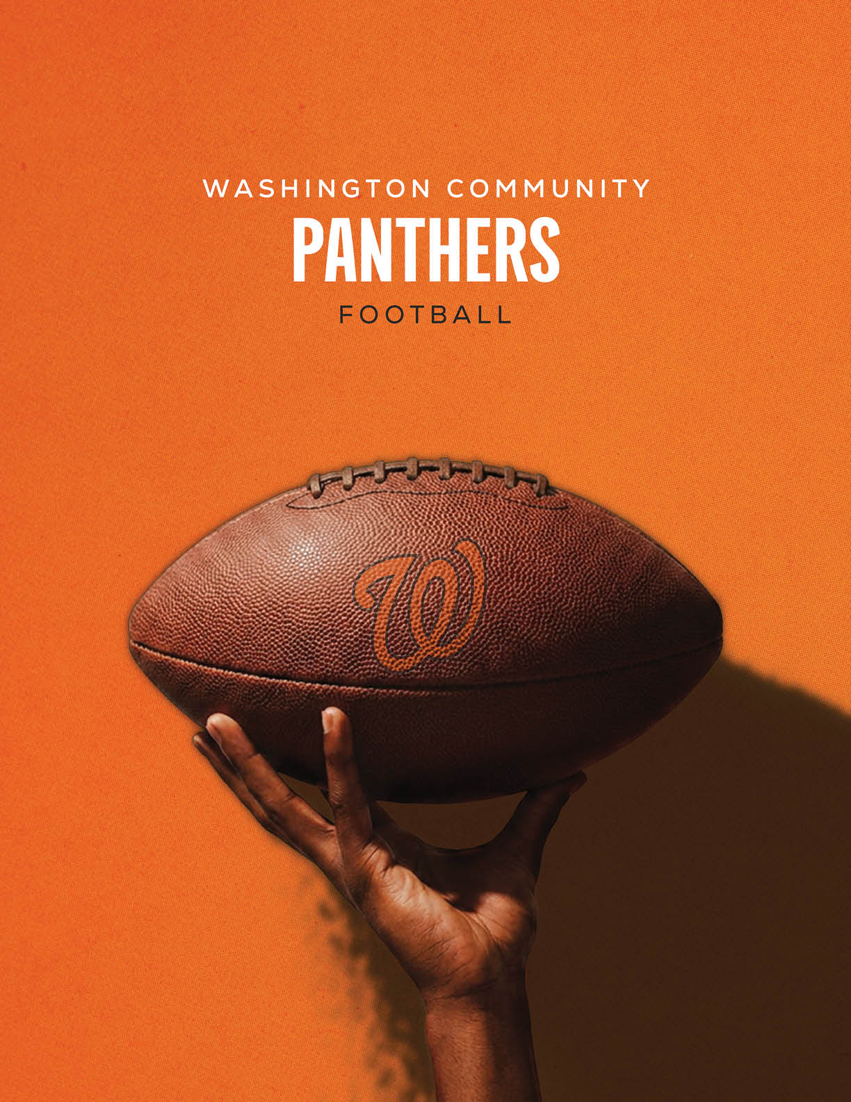 A hand is holding up a football with a “W" logo against an orange background with the text Washington Community Panthers Football above it. Description generated by AI