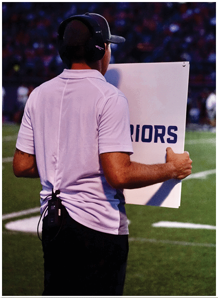 A football player wearing a blue and white uniform. Description generated by AI