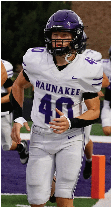 A football player running on the field. Description generated by AI