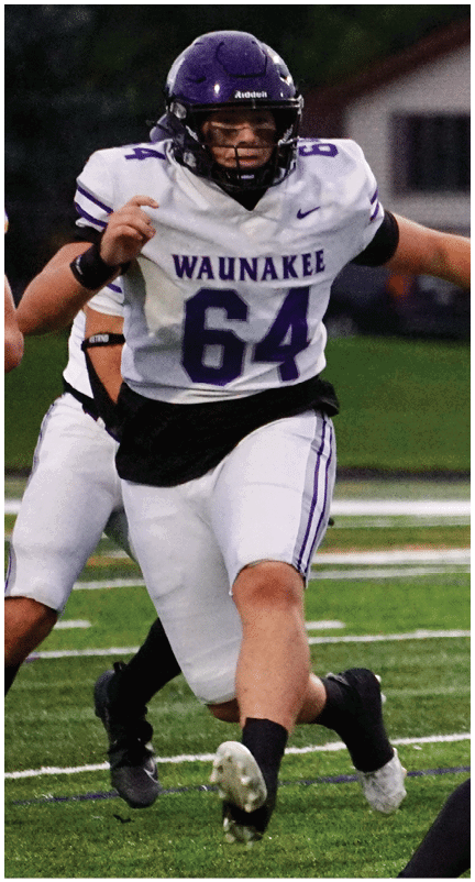 A football player running on the field. Description generated by AI