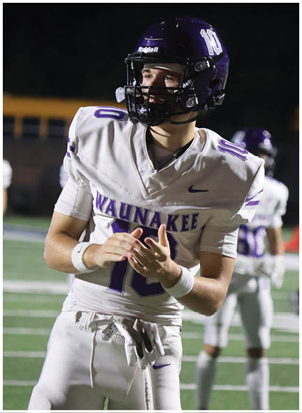 A football player wearing a blue and white uniform. Description generated by AI
