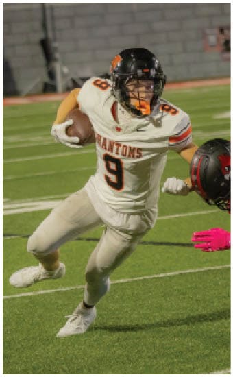 Two football players wearing blue and white uniforms. Description generated by AI