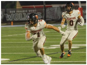 A football player running on the field. Description generated by AI