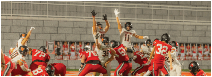 A group of football players on a field. Description generated by AI