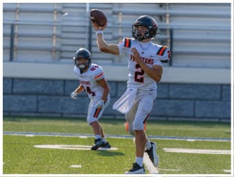 A football player running on the field. Description generated by AI