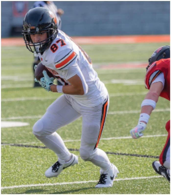 A group of football players on a field. Description generated by AI