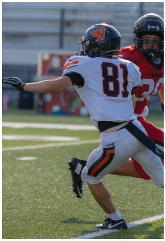 A group of football players celebrating a touchdown. Description generated by AI