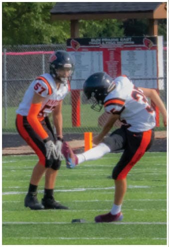 A group of football players celebrating a touchdown. Description generated by AI