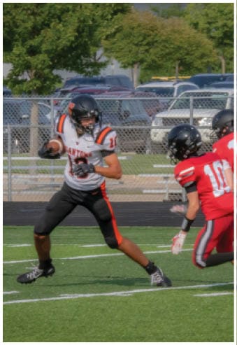 A group of football players celebrating a touchdown. Description generated by AI