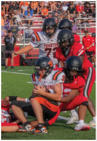 A group of football players celebrating a touchdown. Description generated by AI