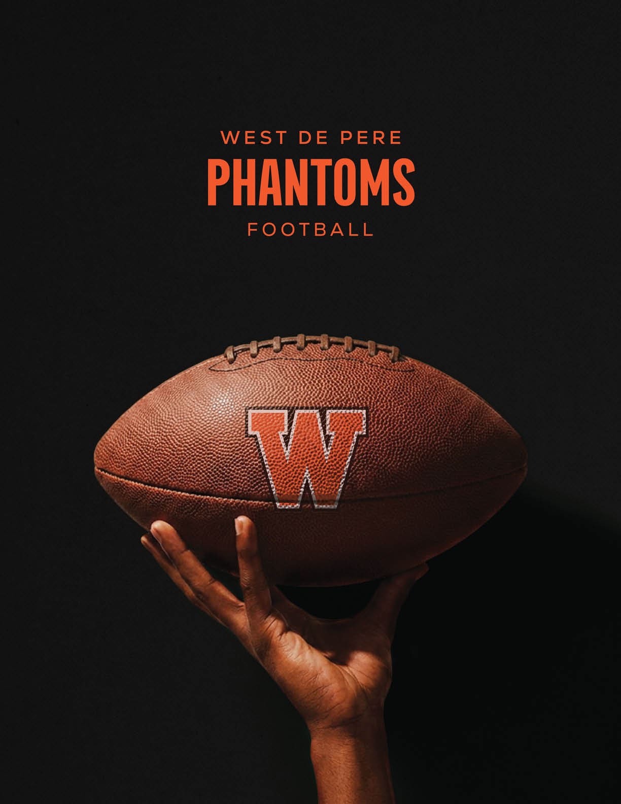 A hand is holding a football with a large letter W on it against a black background with the text West De Pere Phantoms Football above. Description generated by AI