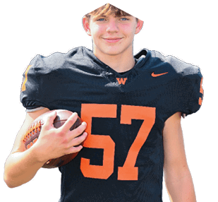 A person wearing black sports pants with an orange “W" and Nike logo is holding a black football helmet with an orange "W" logo. Description generated by AI