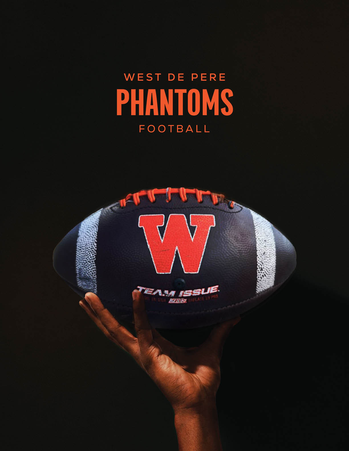 A hand is holding a black football with white stripes and a red “W" logo, with the text "West De Pere Phantoms Football" above it on a dark background. Description generated by AI