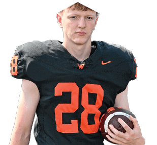 A person wearing a black football jersey with the number 28 in orange is holding a football. Description generated by AI