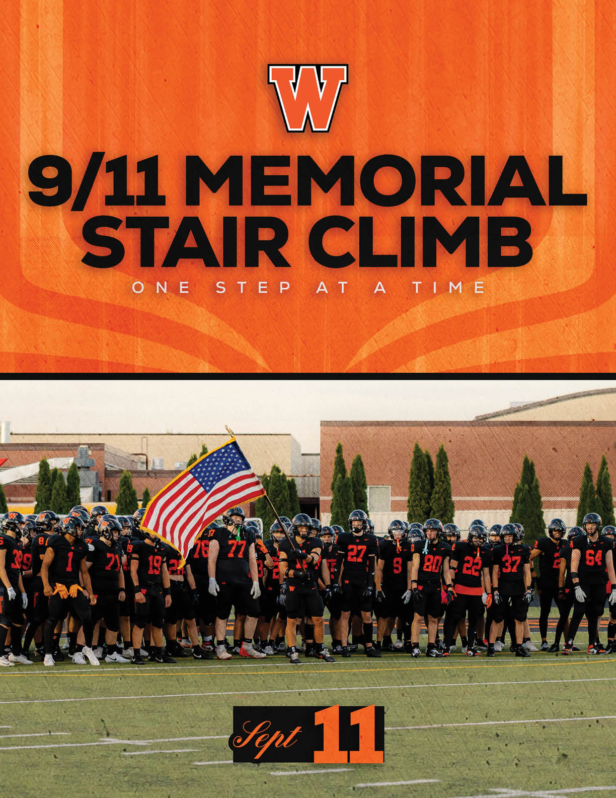 A large group of people in black and orange sports uniforms stand together on a field holding an American flag beneath a banner reading 9/11 Memorial Stair Climb with the date Sept 11. Description generated by AI
