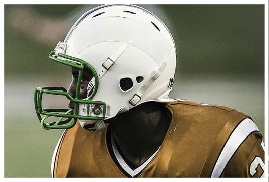 A football player wearing a helmet and jersey with the number 24. Description generated by AI