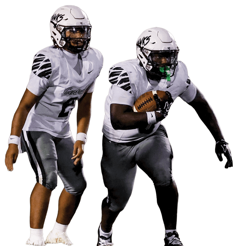 Two people in football uniforms are on a field, with one holding a football and the other standing behind. Descripci n generada con IA