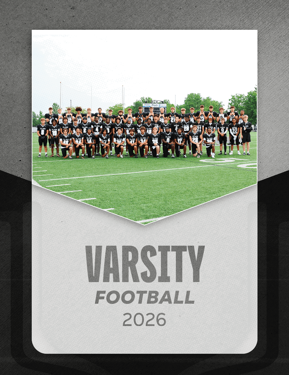 A group of football players sitting on a bench. Description generated by AI