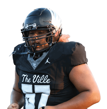A person wearing a black football uniform and helmet with “The Ville" written on the jersey is standing on a field with a blurred crowd in the background. Descripci n generada con IA