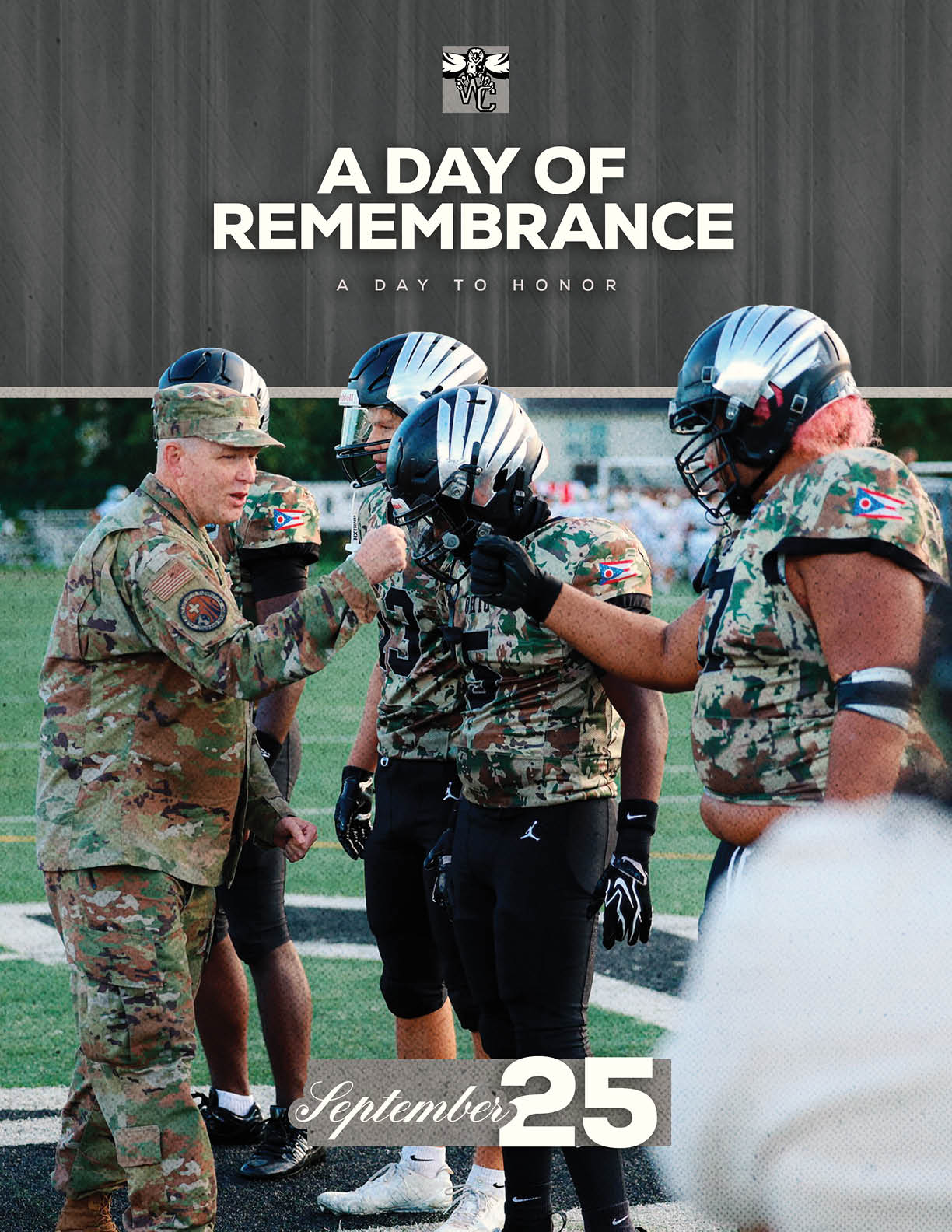 A person in military uniform is pinning a medal or badge on a person wearing a football uniform with a camouflage jersey and helmet on a sports field with the text “A Day of Remembrance" and "September 25" above. Descripci n generada con IA