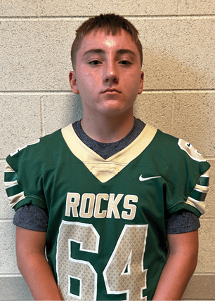 A young man wearing a white and black jersey with the number 14 on it. Description generated by AI