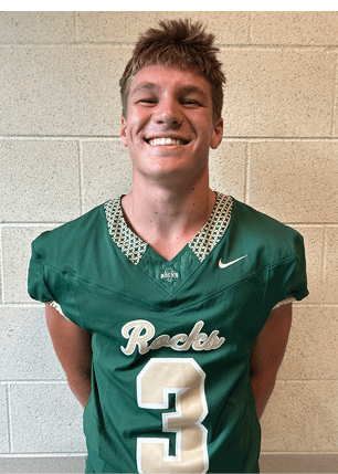 A young man wearing a white and black jersey with the number 14 on it. Description generated by AI