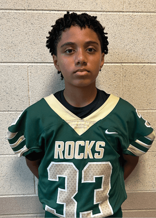 A young man wearing a white and black jersey with the number 14 on it. Description generated by AI