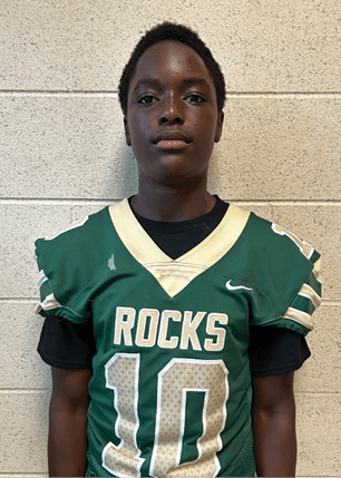A young man wearing a white and black jersey with the number 14 on it. Description generated by AI