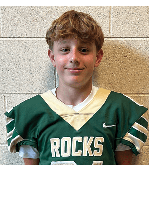 A young man wearing a white and black jersey with the number 14 on it. Description generated by AI