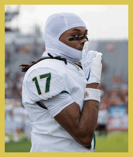 A football player in a white uniform is running with a football in his hand. AI generated content