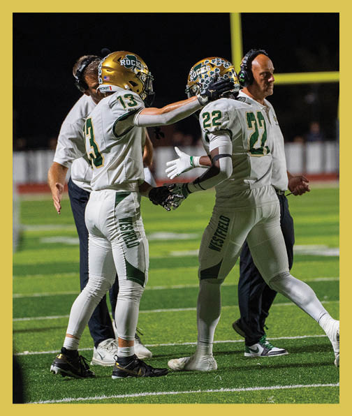 A football player in a white uniform is running with a football in his hand. AI generated content
