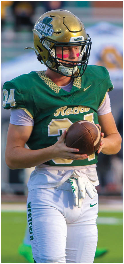 A football player wearing a blue and white uniform. Description generated by AI