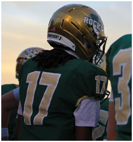 A football player running on the field. Description generated by AI