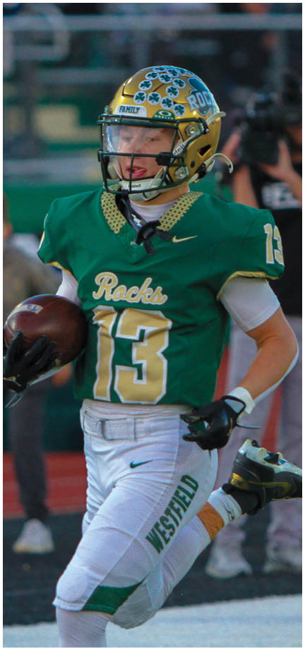 A football player wearing a blue and white uniform. Description generated by AI