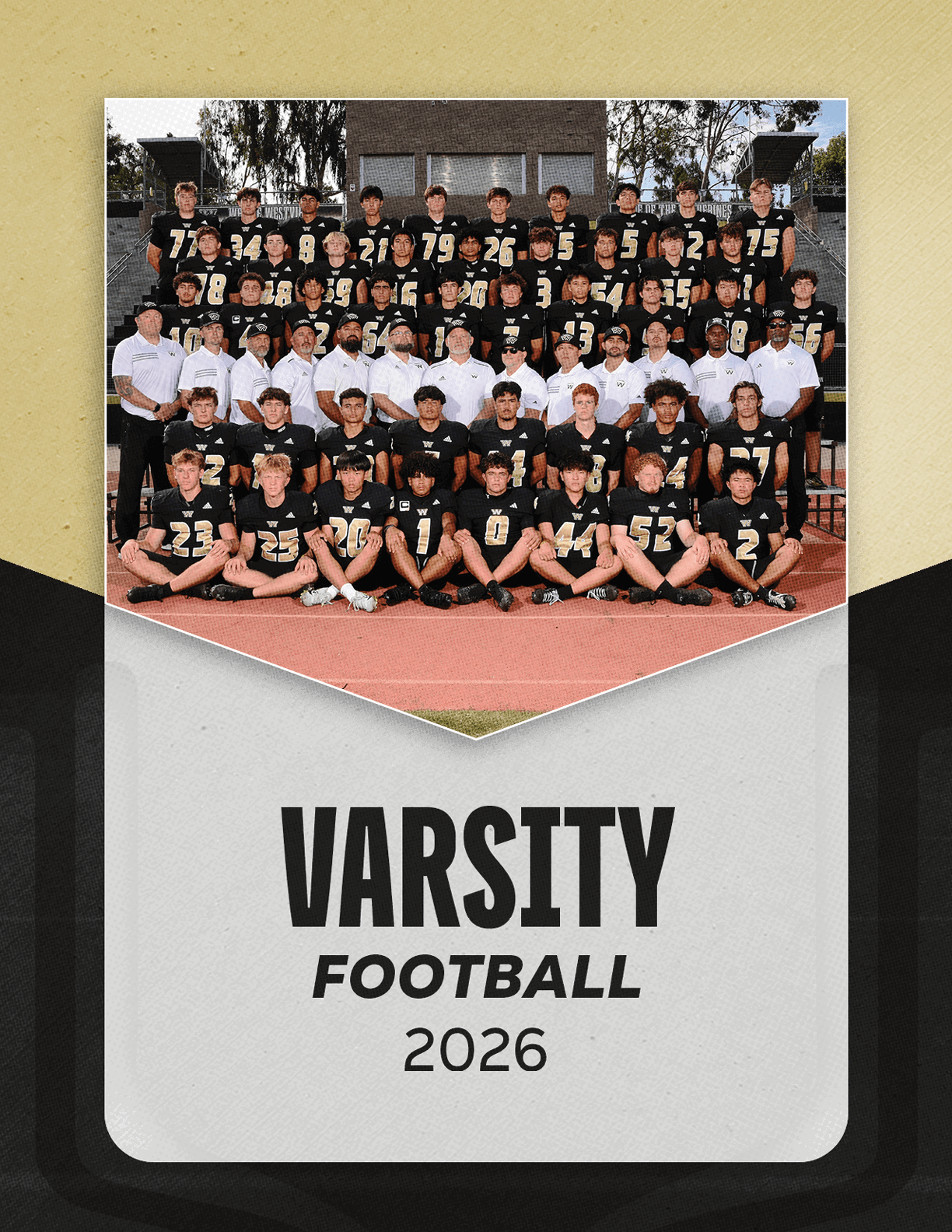 A large group of people wearing black football uniforms and white shirts pose together on bleachers above a track with the text varsity football 2026 below them. Description generated by AI