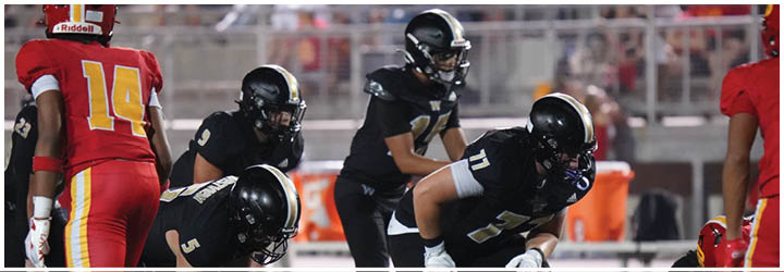 A group of football players on a field. Description generated by AI