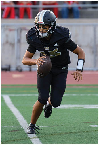 A football player running on the field. Description generated by AI