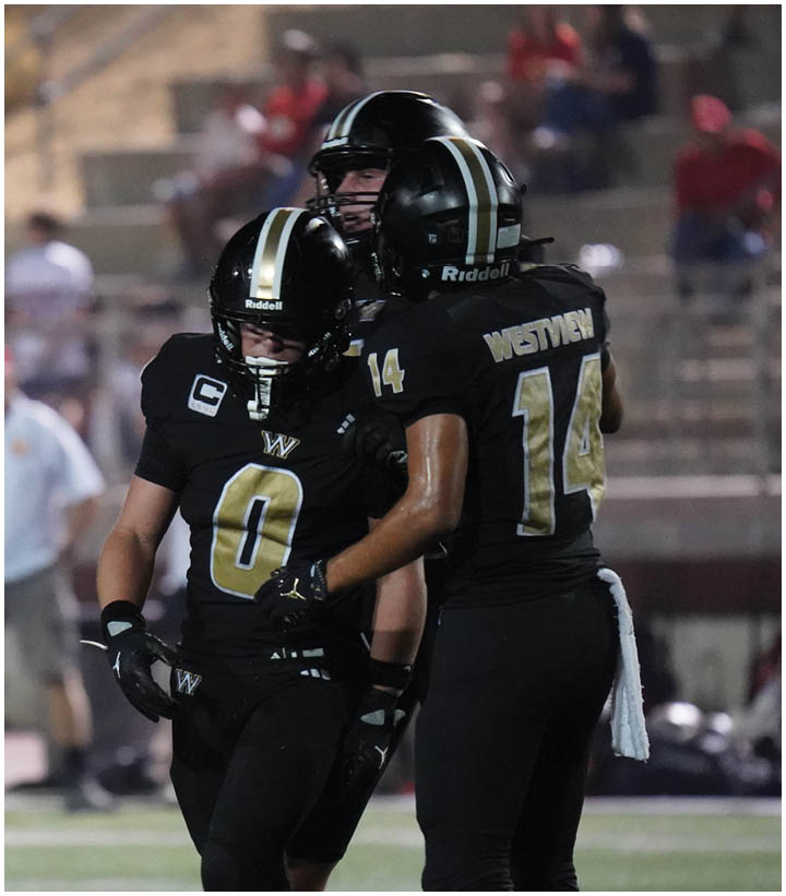 A group of football players wearing black and white uniforms. Description generated by AI