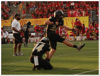 A football player running on the field. Description generated by AI