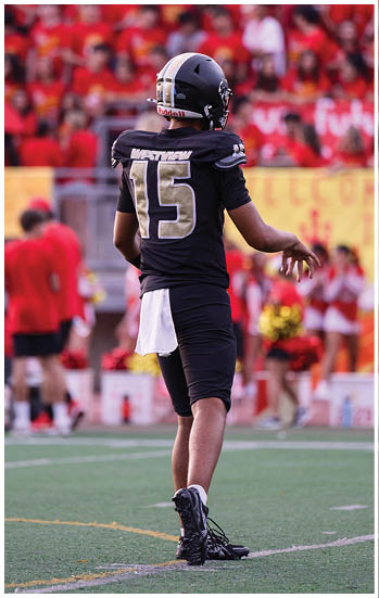 A football player running on the field. Description generated by AI
