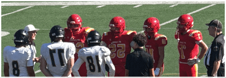 A group of football players on a field. Description generated by AI