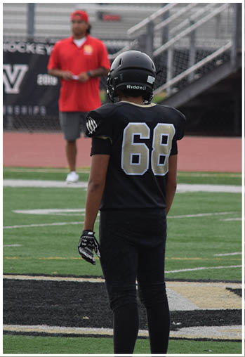 A football player running on the field. Description generated by AI