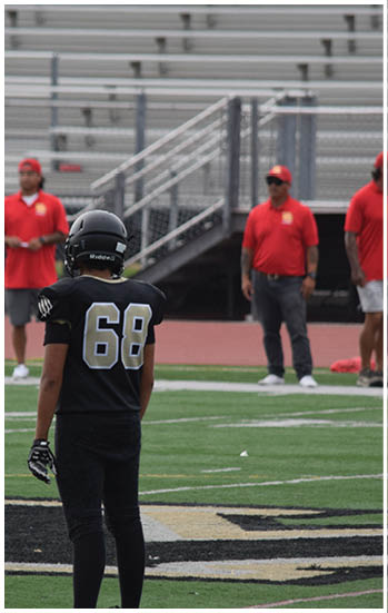 A football player running on the field. Description generated by AI