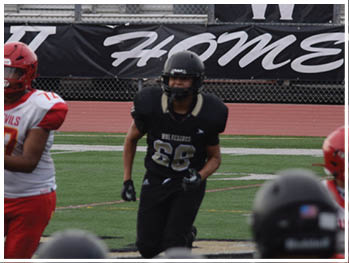 A football player running on the field. Description generated by AI