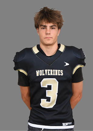 A young man wearing a white and black jersey with the number 14 on it. Description generated by AI